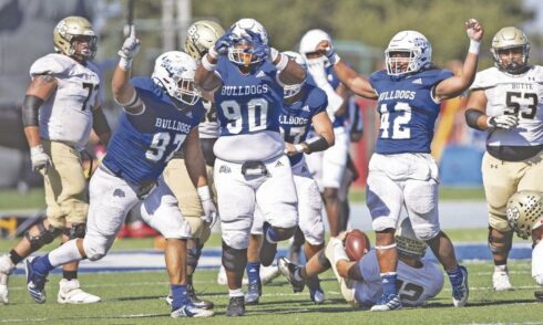 CSM defenders Kavika Baumgartner, left, Fale Mosley, middle, and Alo Mata’u celebrate a sack in the third quarter Saturday at College Heights Stadium. Photo by Patrick Nguyen.
