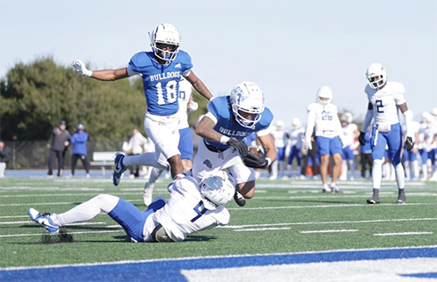CSM receiver Fidel Pitts barrels into the end zone in the Bulldogs’ rout of Modesto in the CCCAA football playoff opener Saturday at College Heights Stadium. Photo by Patrick Nguyen.