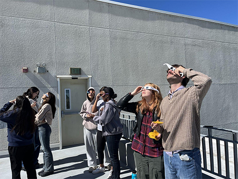 College of San Mateo students Maige Brody and Aidan Pechnik view the eclipse. Photo by Holly Rusch/Daily Journal.